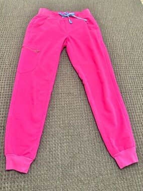 Figs pink jogger scrub pants.  Size XS